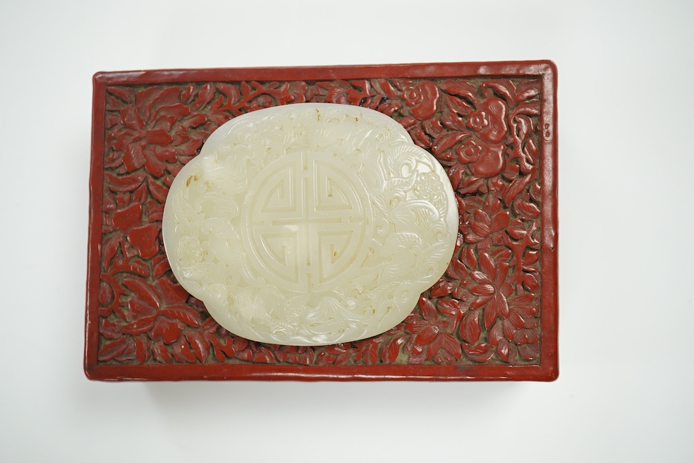 A Chinese carved jade mounted cinnabar lacquer box, 19th / 20th century, 14cm wide. Condition - fair, commensurate with age